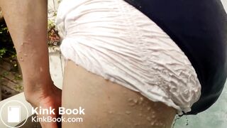 Girl messing her diaper under swimsuit at jacuzzi.