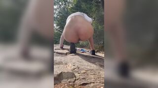 Girl shits outdoors on a hiking trip
