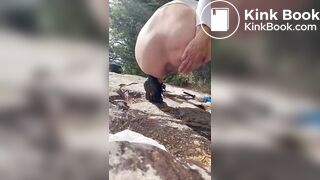 Girl shits outdoors on a hiking trip