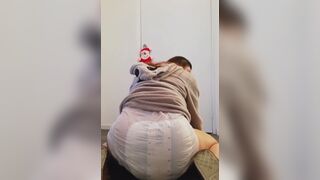 Girl sits and squishes in her poopy diaper