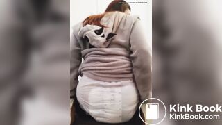 Girl sits and squishes in her poopy diaper