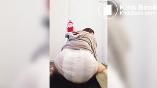 Girl sits and squishes in her poopy diaper