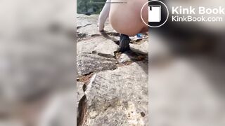 Cute girl outdoor shitting on the rocks