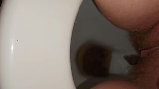 Girl with hairy pussy poops filmed between the legs