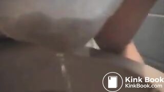 Messing her white undies above the toilet..