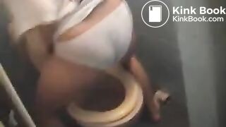 Messing her white undies above the toilet..