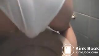 Messing her white undies above the toilet..