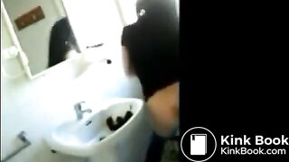 Woman shitting in the sink