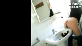 Woman shitting in the sink