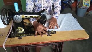 African lady poops on her sewing at a warehouse..