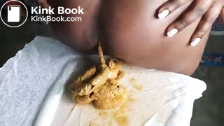 African lady poops on her sewing at a warehouse..