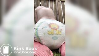 GIrl poops her diaper in her backyard