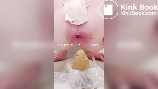 Young cute Japanese woman is pooping with her hand