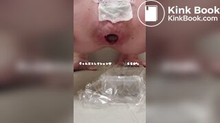 Young cute Japanese woman is pooping with her hand