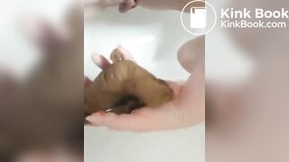 Woman poops in the palm of her hand