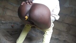 African lady relieves herself in an empty building..