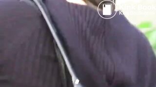 An Asian lady poops in the bushes..