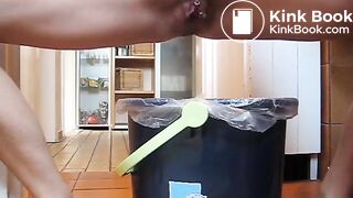 German lady defecates in a trash can..