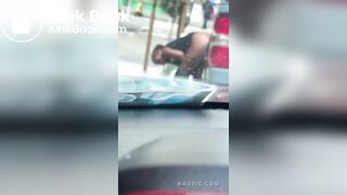 Woman shits on the street.