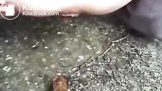 White girl poops outside near a farm