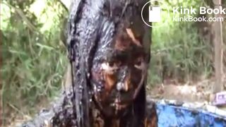 Thai girl taking a bath in cow shit.