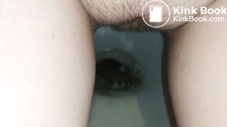 Showing hairy pussy while shitting