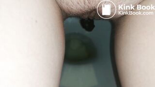 Showing hairy pussy while shitting