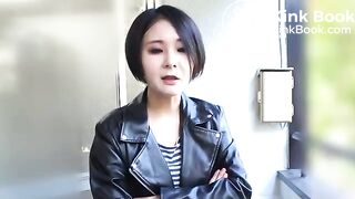 Asian woman in leather jacket pooping