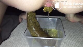 Girl shitting big turd into a plastic container