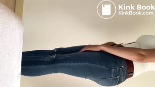 Sexy Woman fills her jeans in the bathroom