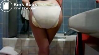 Amateur girl shitting her diaper in the bathroom