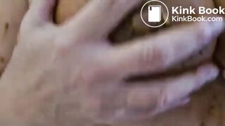 a woman spreads shit on her big tits