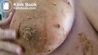 a woman spreads shit on her big tits
