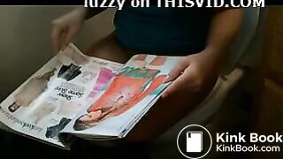 Attractive brunette reading while taking a shit