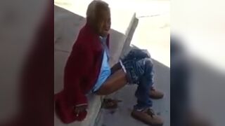Old and homeless woman pooping in the streets.