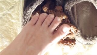 Girl squishes toes in shit