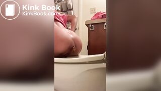 In the bathroom pooping on the toilet