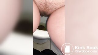Pooping and peeing sitting in a public toilet stall