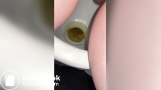 Pooping and peeing sitting in a public toilet stall
