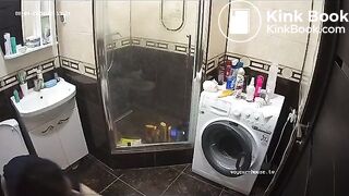 A young chick pooping in bathroom while using phone