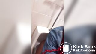 Nasty ebony chick shits in urinal and spits