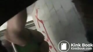 Girl in green bikini takes a dump in a public toilet.