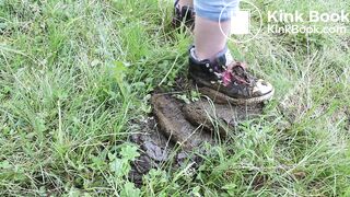 Girl trashing shoes in old cow shit