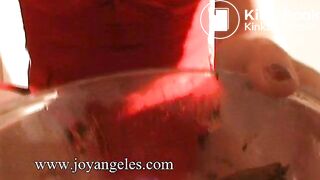 Sabrina in a red dress poops in a bowl