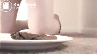 Woman shit big turd on a white plate