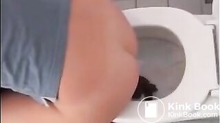 Sexy blonde girl shitting in the toilet
