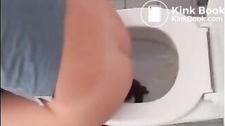 Sexy blonde girl shitting in the toilet