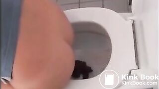 Sexy blonde girl shitting in the toilet