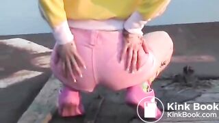 Pooping in her pink and white panties outdoors