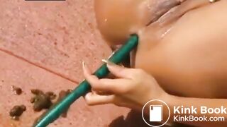 DIRTY WHORE SHITTING IN THE GARDEN FILLING WATER ASSHOLE